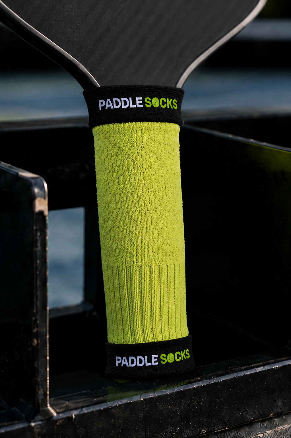 Close up of the black flecked Paddle Socks grip sleeve showing its neon logo bands