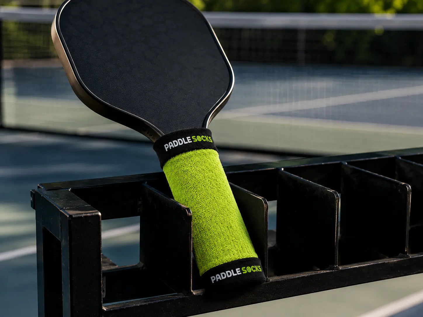 Paddle Socks covering a full pickleball paddle handle in a paddle rack